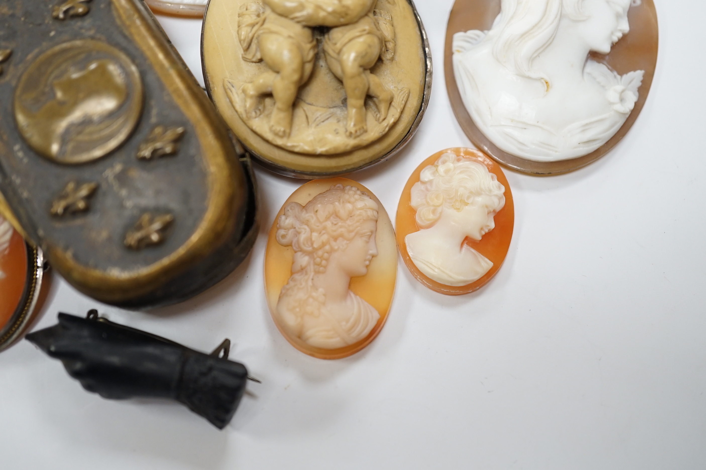 Five assorted unmounted carved cameo shells, largest 57mm, four other mounted cameo brooches including three shell, two base metal vestas and a box and sundry other items.
